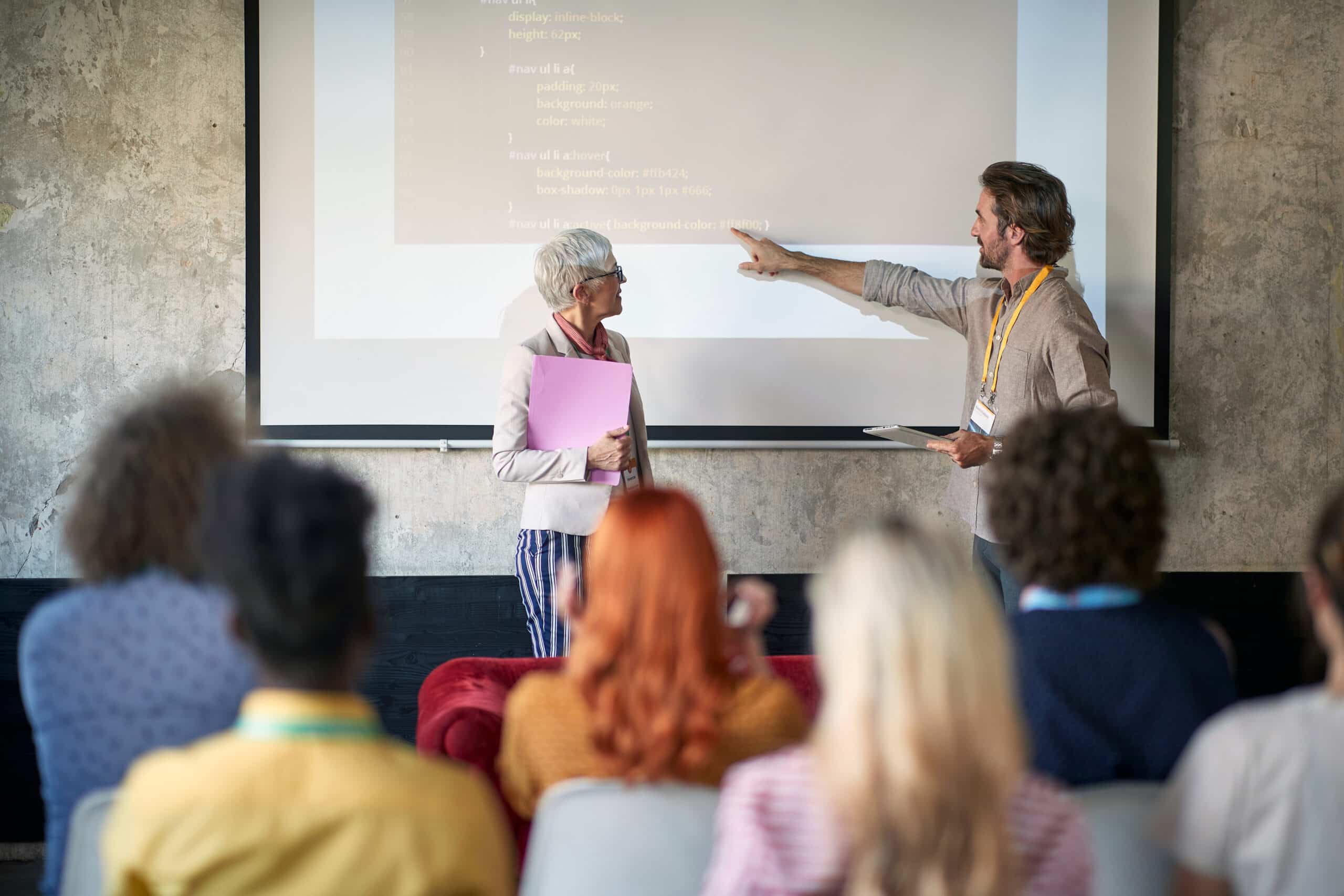 Company employees at a presentation in a working atmosphere in the conference room.