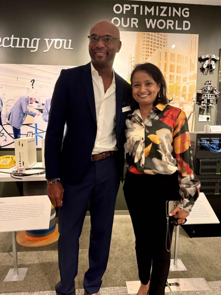 Two people posing in an event space.