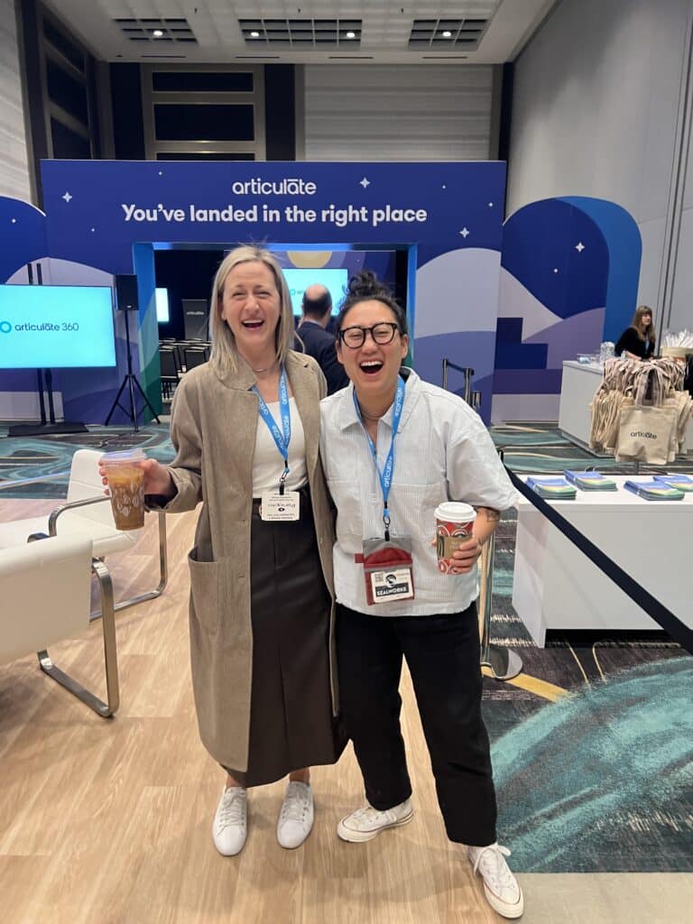 Two people laughing and smiling in an Articuland event space.