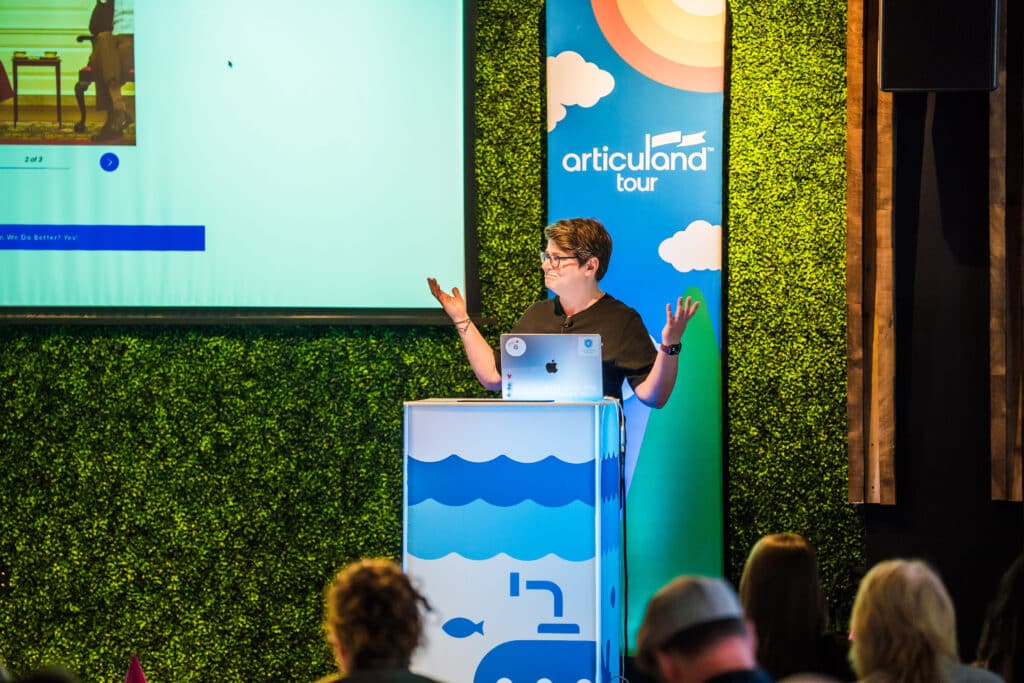 A person presenting on the stage at an Articuland event.