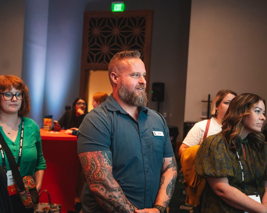 A candid of a bearded person, listening intently.